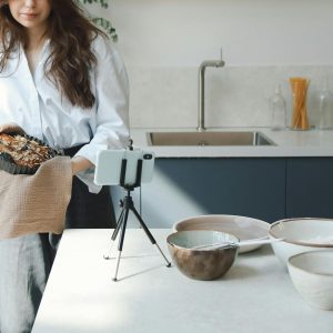 A Woman Blogging While Cooking