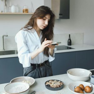 A Woman Taking Photo of a Food