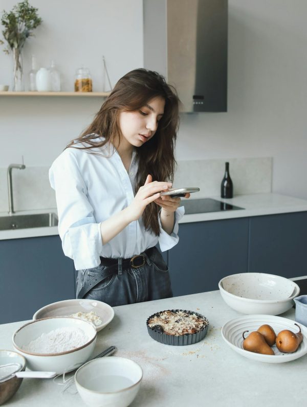 A Woman Taking Photo of a Food