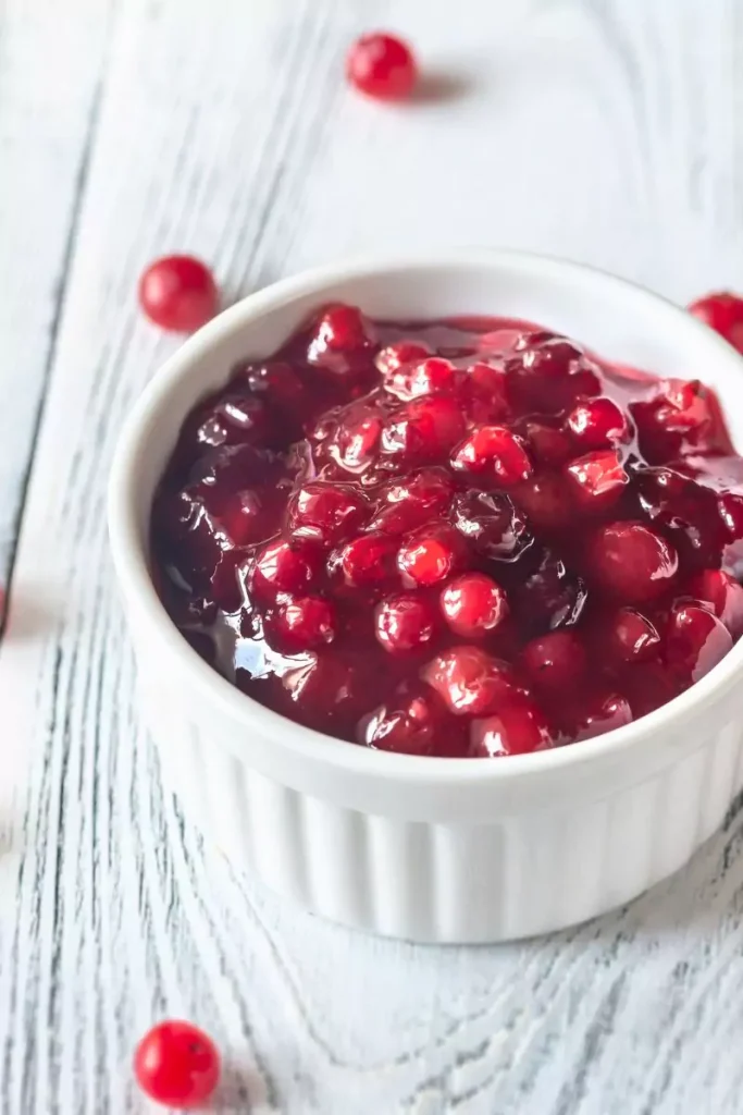 Top-down view of cranberry dip with cream cheese topped with cranberry compote in a bowl.