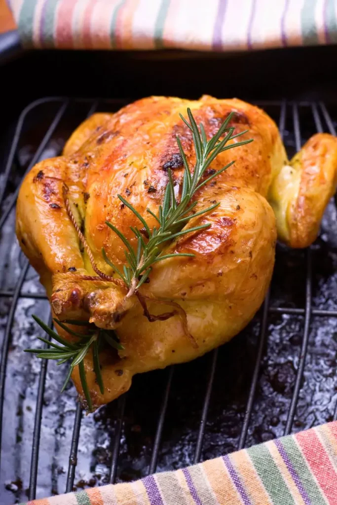 Glazed Cornish hens with a golden brown finish, garnished with a sweet apricot glaze.