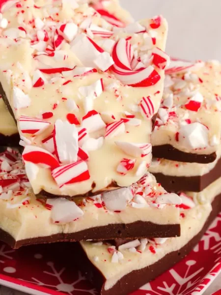 A slice of Layered Candy Cane Dessert served on a white plate