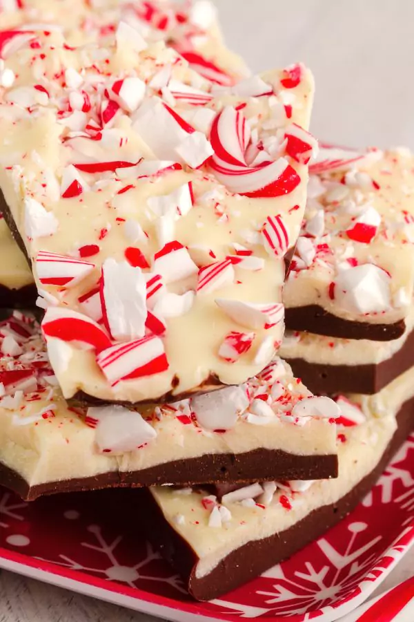 A slice of Layered Candy Cane Dessert served on a white plate