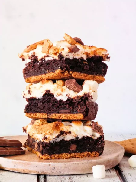 Fudgy peppermint mocha cookie bars topped with white chocolate frosting and crushed peppermint candy canes.