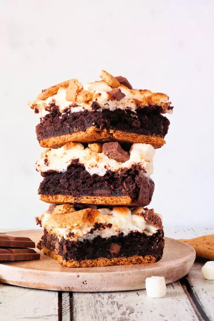 Fudgy peppermint mocha cookie bars topped with white chocolate frosting and crushed peppermint candy canes.